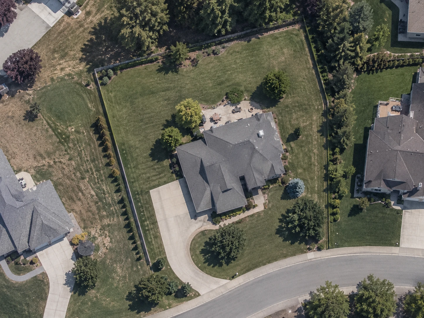 An aerial view of a house on a cul-de-sac with its whole lot traced and measured at 18,742 square feet. The traced outline follows the curve of the street frontage with a run of closely spaced points, and crosses the straight fence lines along the sides with a single point at each end.