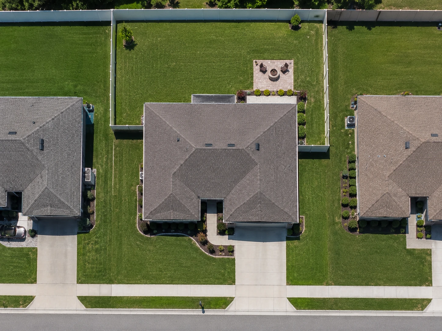 Aerial view of a residential property with the front lawn and side lawn traced as separate measured areas