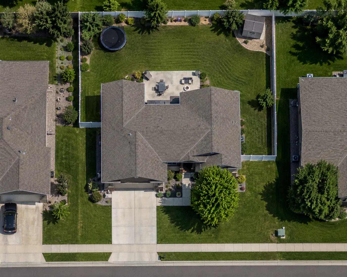 Aerial view of a residential lot with the back lawn, side lawn, and front lawn each traced as a separate measured area and labeled with its square footage