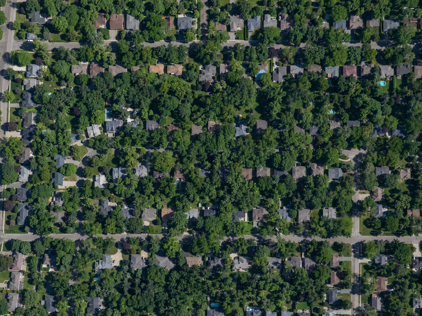 Aerial satellite view of a residential neighborhood before zooming in to measure a single property